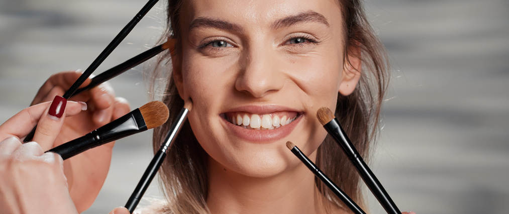 girl posing with brushes