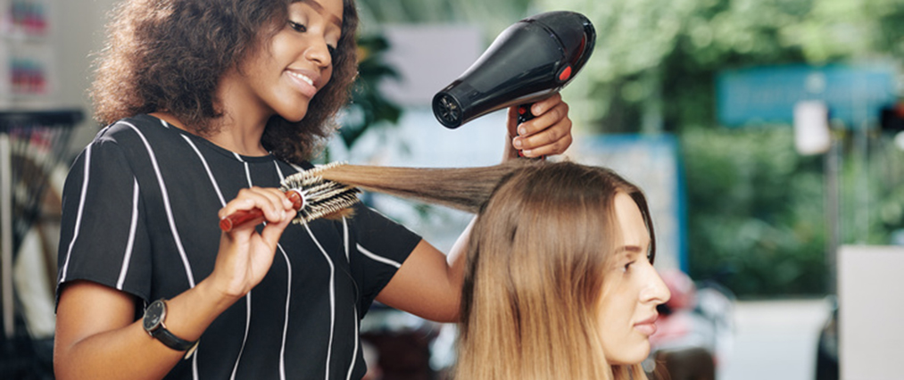 hairdresser working in beauty salon featured
