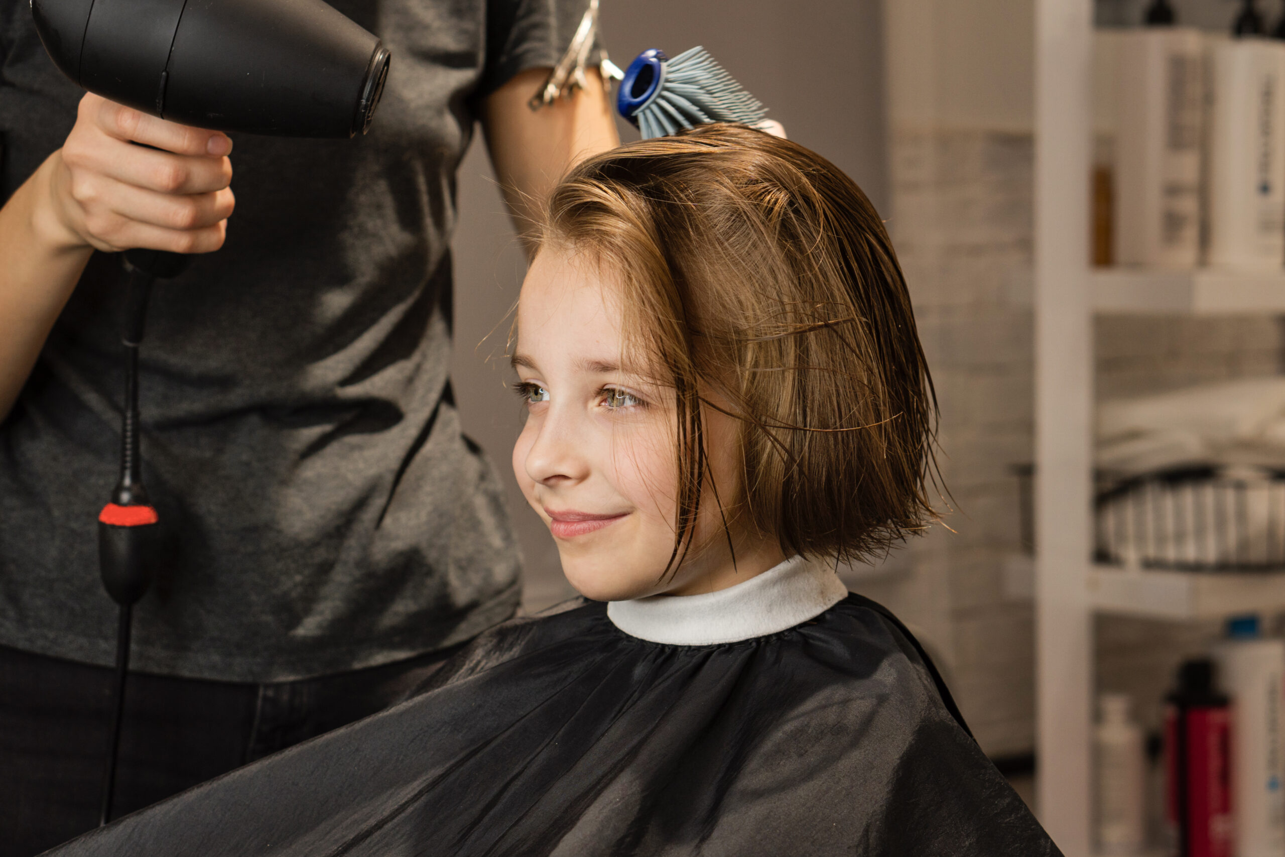little girl at salon getting trim