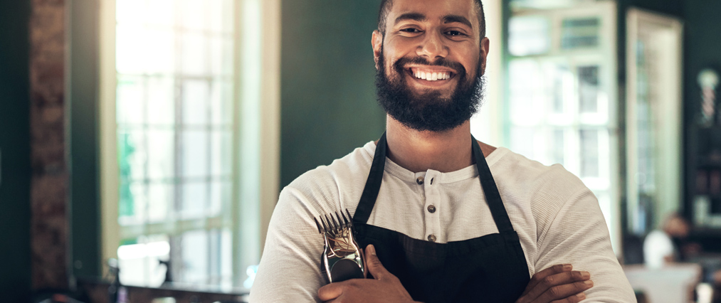 man with shears posing proudly