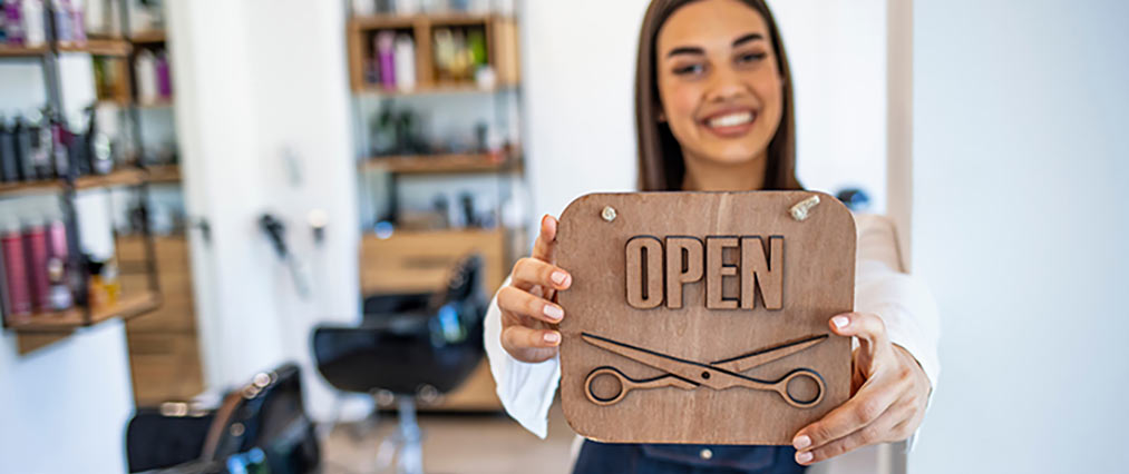 holding an open sign featured